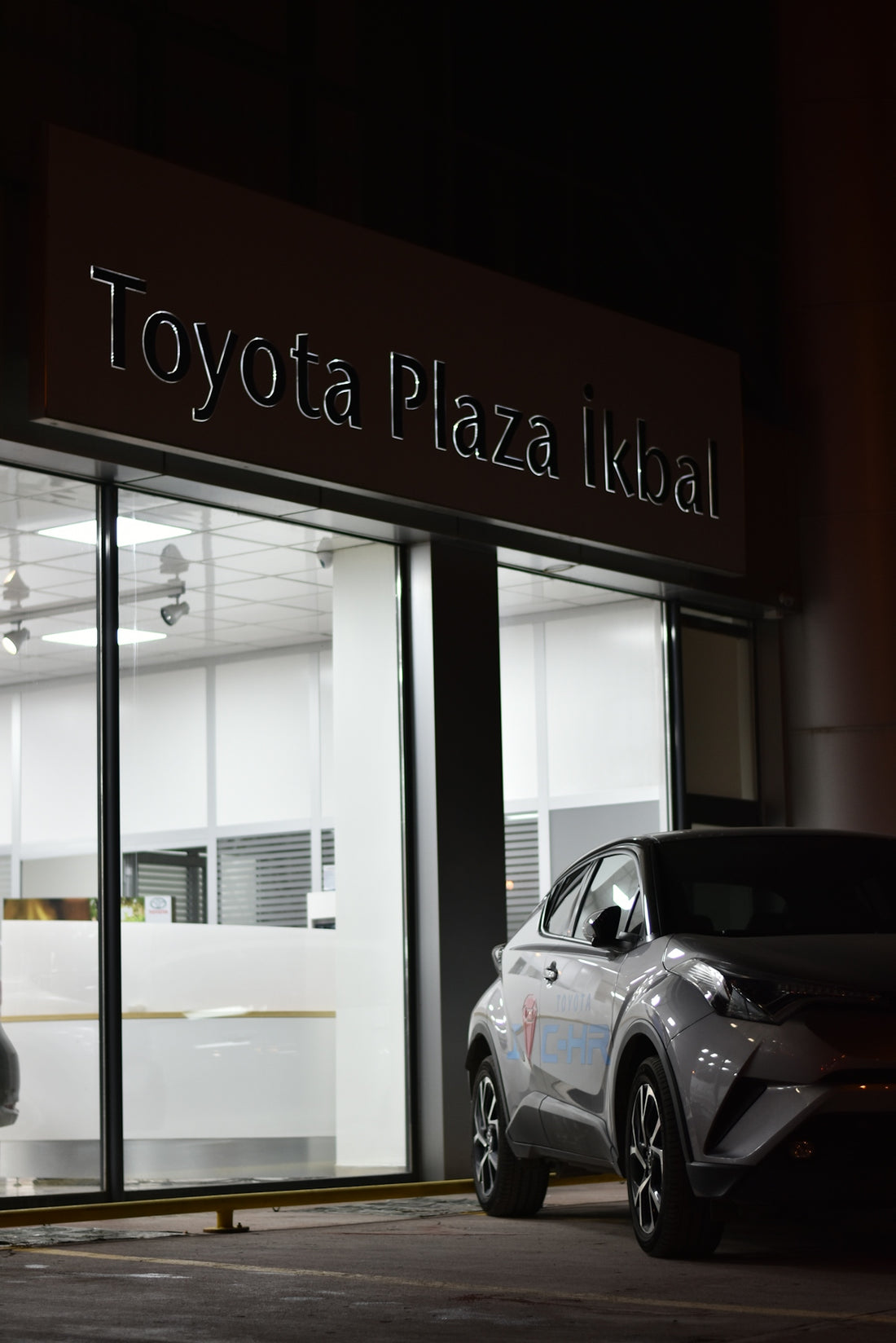 car parked beside Toyota Plaza Ikbal building during night